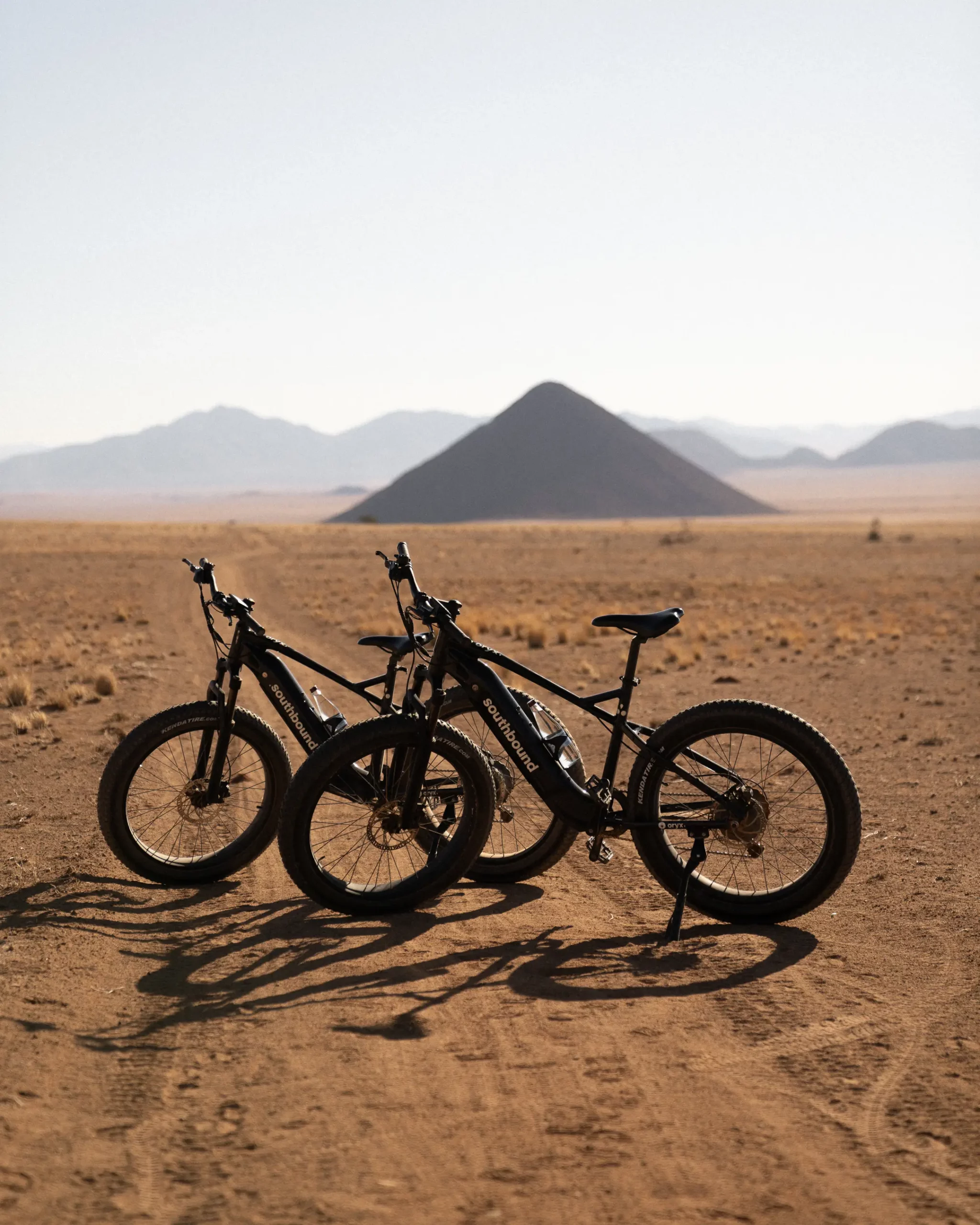 Zannier Sonop, Hardap, Namibia - Electric fat bikes on a trail against the backdrop of the Namib Dessert